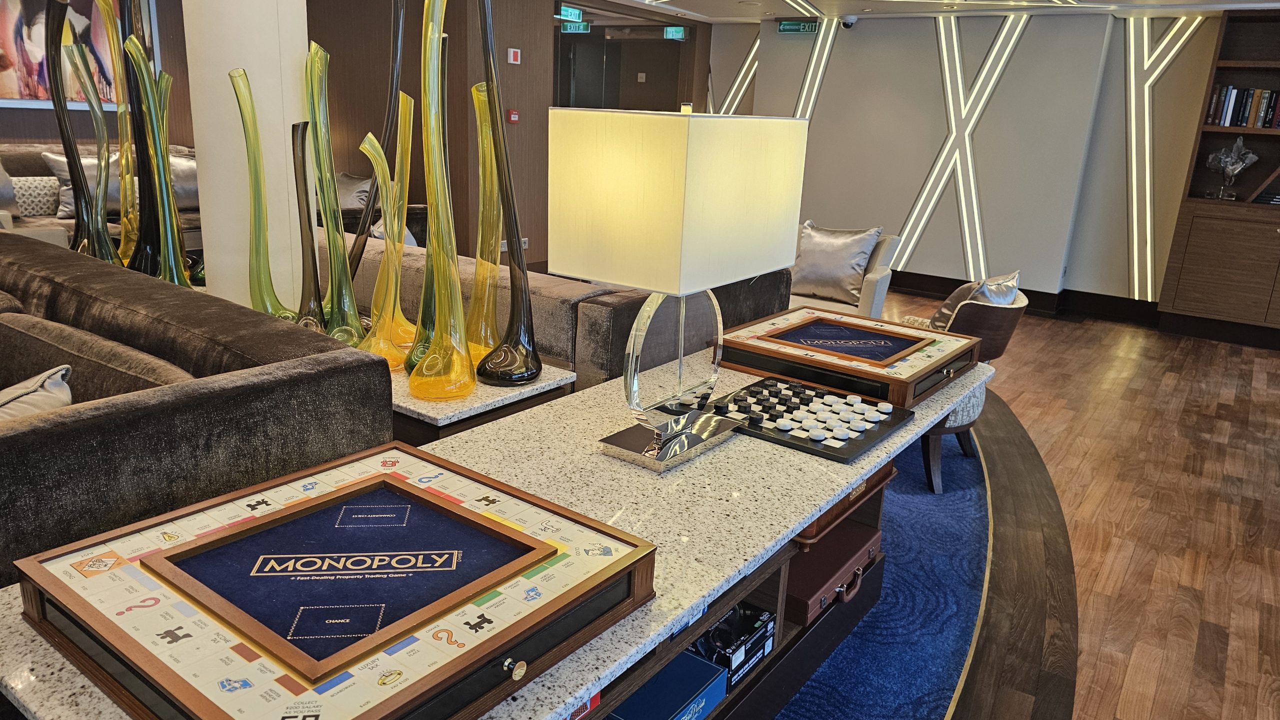 The Haven Lounge Elegant cruise ship lounge with board games and soft lighting for a relaxed luxury atmosphere.
