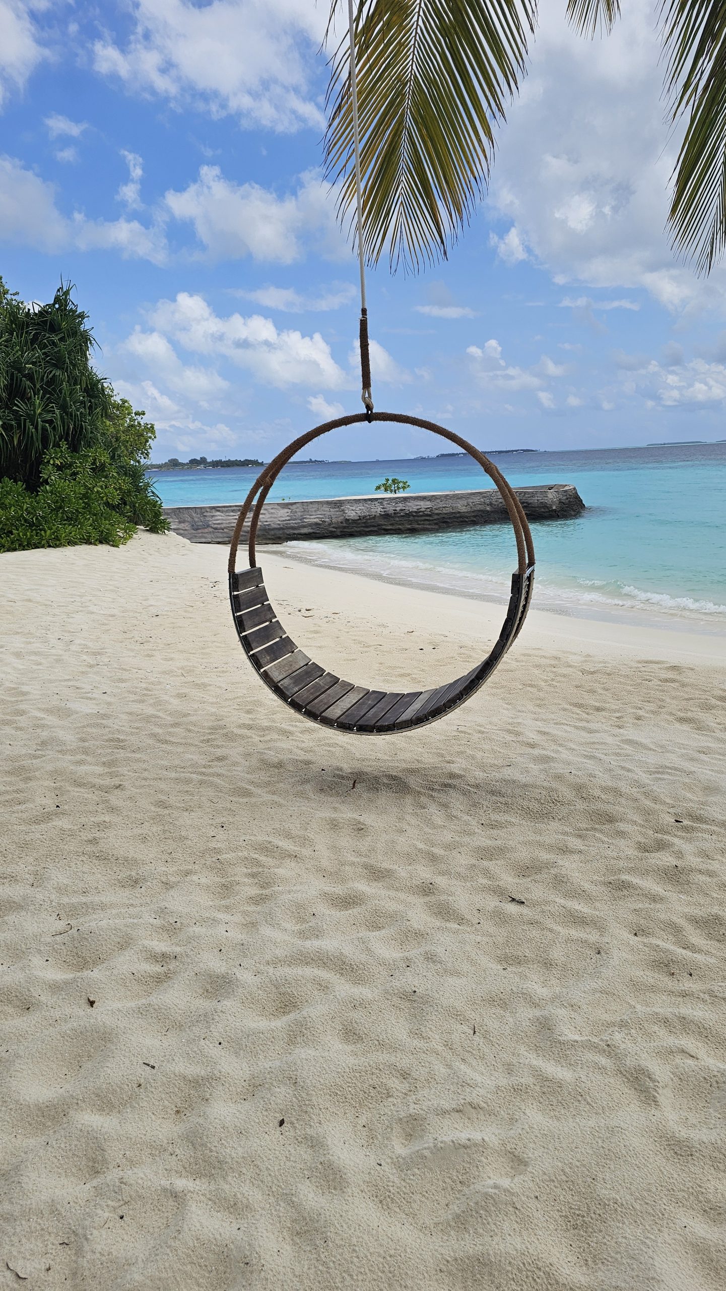 Beach swing overlooking turquoise water at a Maldives island resort
