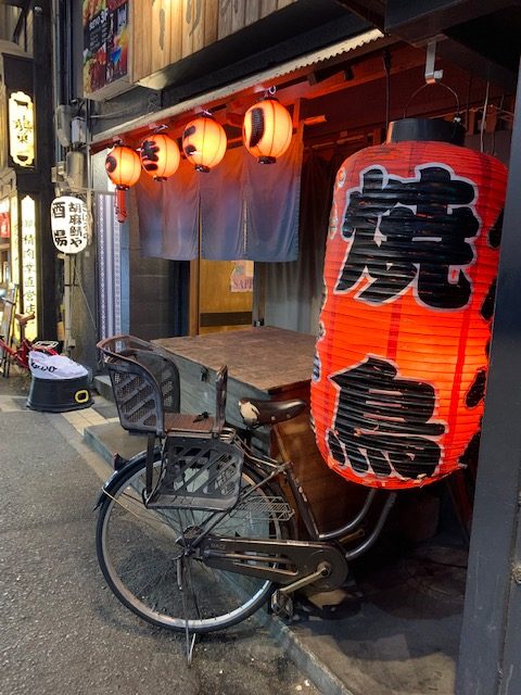 Traditional Japanese lantern and bicycle outside a small street restaurant in Tokyo