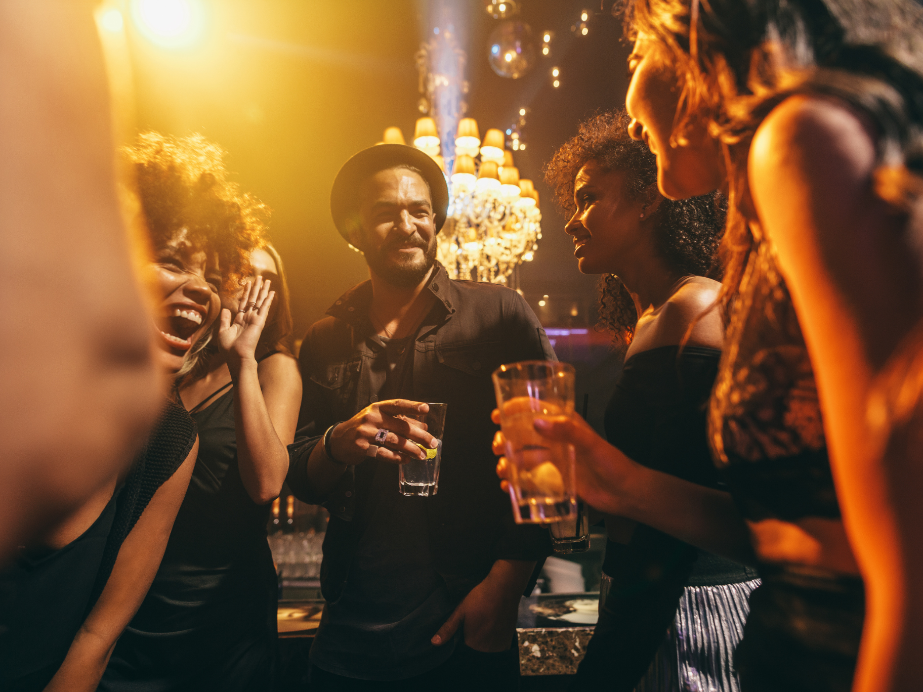 Festival Atmosphere & Shared Travel Experiences Friends enjoying drinks and conversation in a lively atmospheric bar during festival season