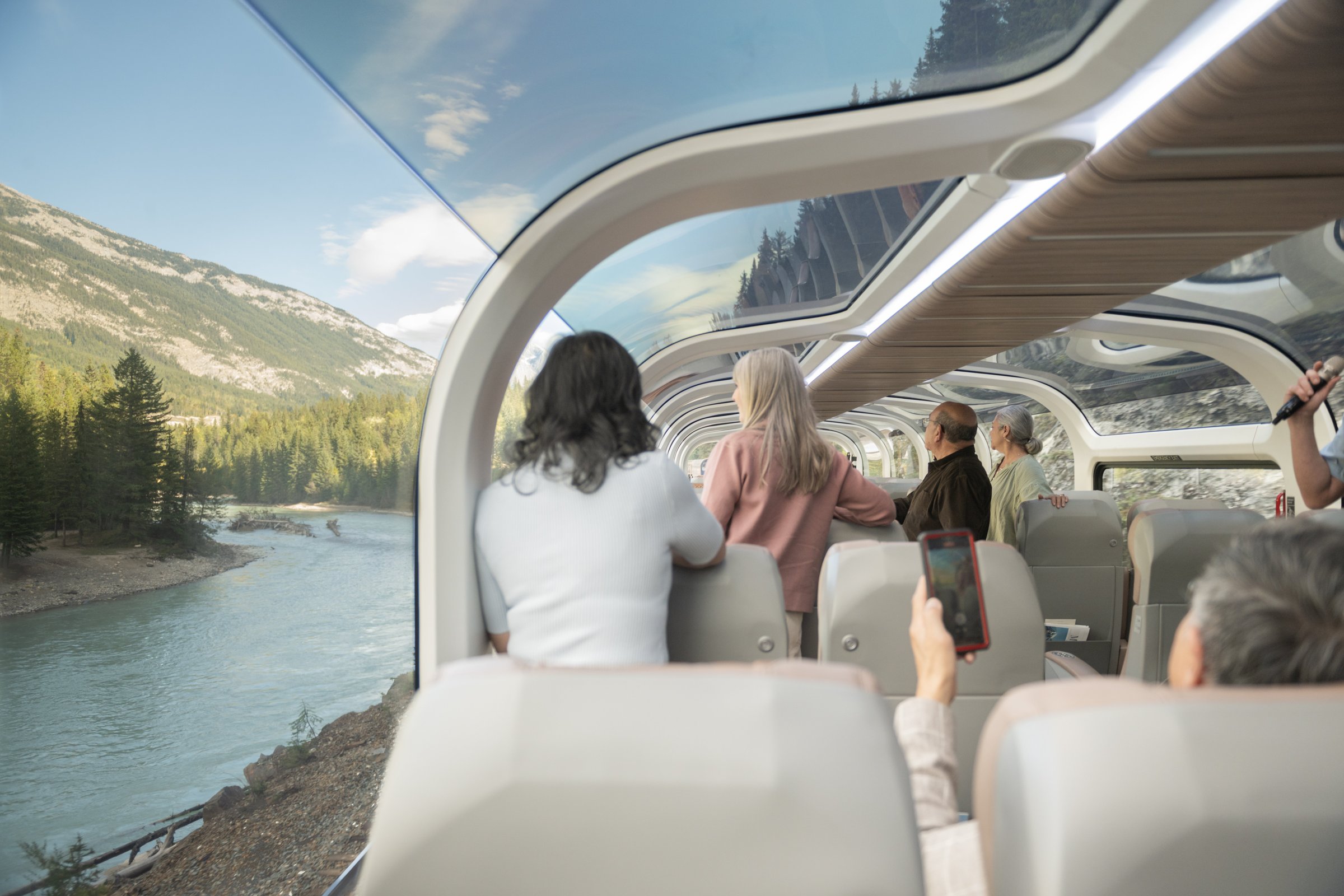 Passengers enjoying the panoramic views from Rocky Mountaineer's GoldLeaf glass-domed carriage